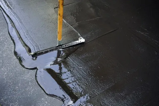 Asphalt sealcoating (seal coat) in Pocatello for cured driveways and parking lots — crack fill and patches first, then protection from sun, water, and deicers.